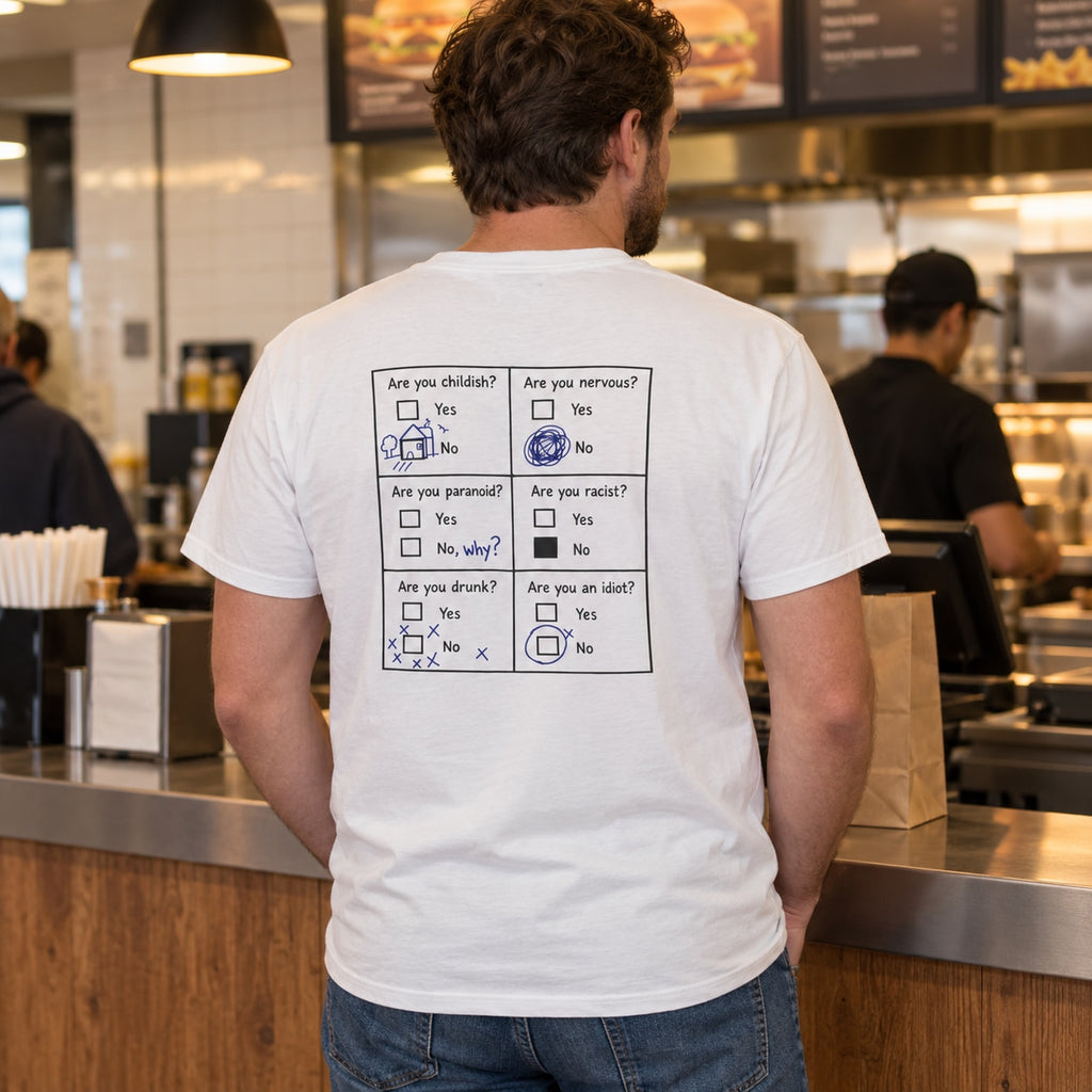 Lifestyle mockup of a man wearing the white questionnaire back-print T-shirt at a burger takeaway counter.