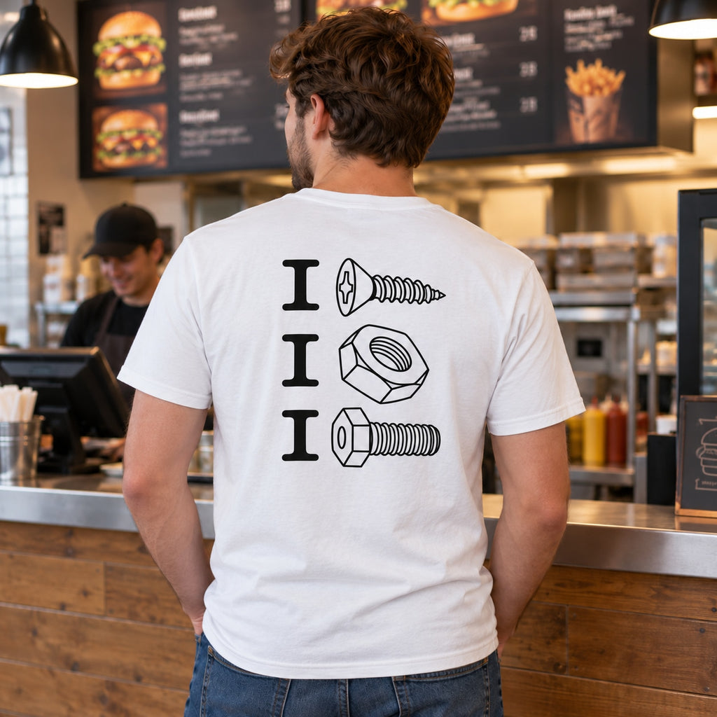 Lifestyle mockup of a man wearing the white screw nut bolt back-print T-shirt at a burger takeaway counter.