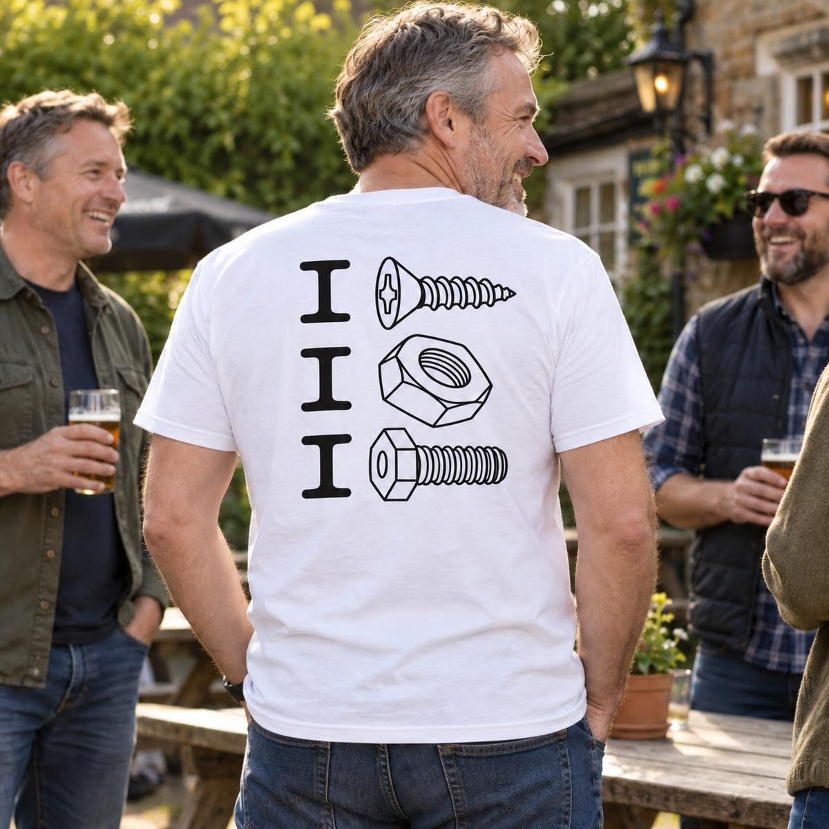 Lifestyle mockup of a man wearing the white screw nut bolt back-print T-shirt with friends in a pub garden.